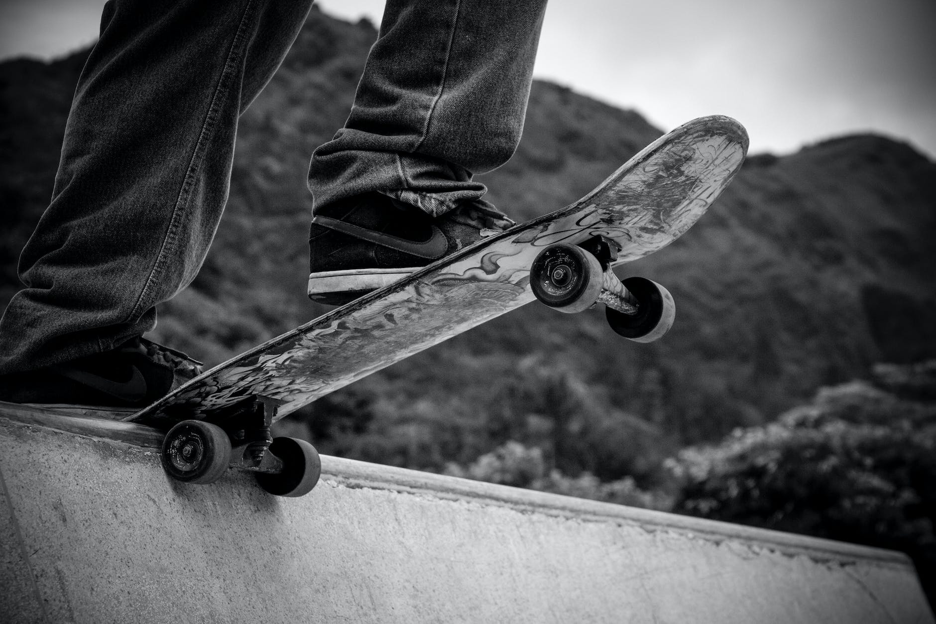 person standing on skateboard grayscale photography